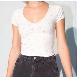 A white crop top with pink flowers all over